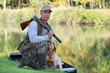 Hunter with dog crouched