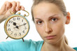 woman with alarm clock, isolated on white