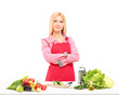 Photo: Smiling female worker with apron preparing salad Smiling female worker with apron preparing salad