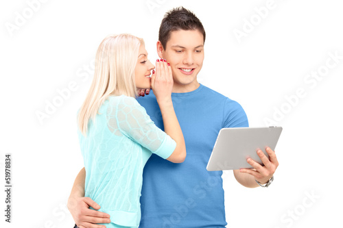 Photo: Two young friends standing close together and looking at a table Two young friends standing close together and looking at a table