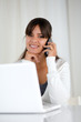 Charming young woman looking at you with cellphone