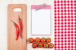 Foto: Recipe cookbook, checkered tablecloth, tomatoes, chili on wood Recipe cookbook, checkered tablecloth, tomatoes, chili on wood