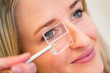Optometry concept - pretty young woman having her eyes examined