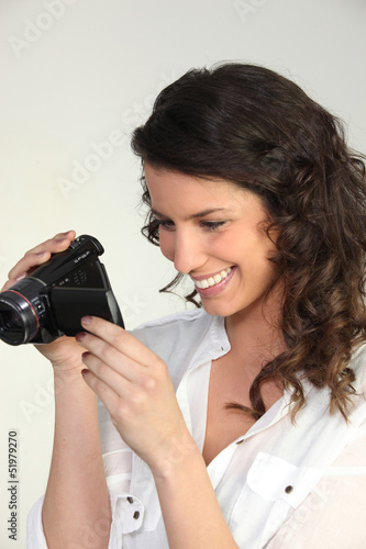 Photo: Woman using a camcorder Woman using a camcorder