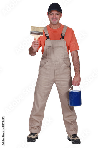 Photo: Happy decorator with brush and pot Happy decorator with brush and pot