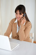 Smiling young woman working with laptop computer