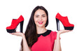 Young woman with choice of shoes on white
