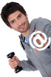Photo: Man holding barbell and at sign Man holding barbell and at sign