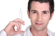 Photo: Man holding syringe Man holding syringe