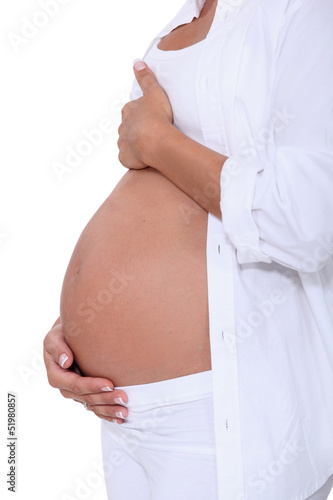 Photo: Woman hugging her pregnant belly Woman hugging her pregnant belly