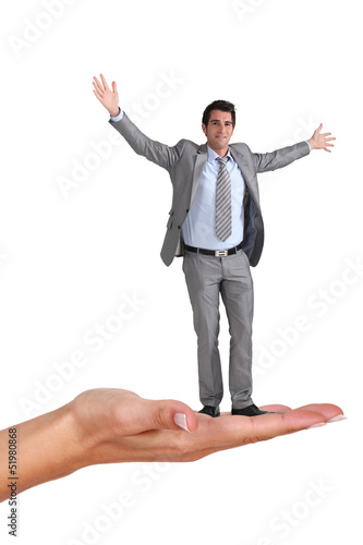 Photo: Businessman standing on a woman's hand Businessman standing on a woman's hand