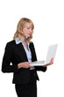 Photo: Blond businesswoman stood with laptop Blond businesswoman stood with laptop
