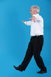 senior businessman pretending to walk on wire