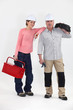Young woman and mature man electricians