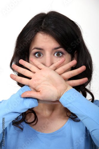 Photo: Woman hiding her mouth Woman hiding her mouth