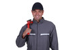 Photo: Cheerful plumber resting wrench on shoulder Cheerful plumber resting wrench on shoulder