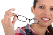 Brunette holding glasses