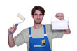 Photo: Decorator with paint and a roller Decorator with paint and a roller