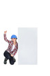 Photo: Excited female builder kneeling by blank poster Excited female builder kneeling by blank poster