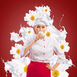 Asian female cook against milk splashes