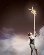 Image of businesswoman climbing the rope