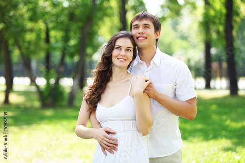 Photo: Young love Couple smiling under blue sky Young love Couple smiling under blue sky