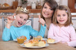 Photo: Mother and two daughters eating cake Mother and two daughters eating cake