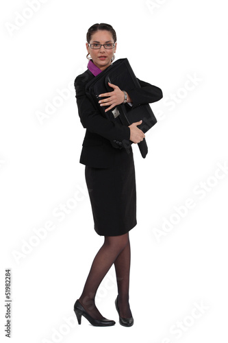 Photo: Businesswoman protecting her briefcase Businesswoman protecting her briefcase