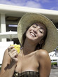 Photo: teen at a pool eating pineapple teen at a pool eating pineapple