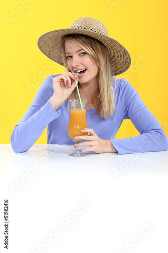 Photo: Woman drinking orange juice Woman drinking orange juice