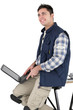 Photo: happy craftsman mason working on his laptop happy craftsman mason working on his laptop