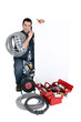 Photo: Tradesman posing with a blank sign and his tools Tradesman posing with a blank sign and his tools