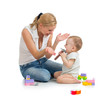 Foto: baby boy and mother playing together with construction set toy baby boy and mother playing together with construction set toy