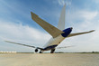 Photo: Rear view at airplane standing on parking from low angle Rear view at airplane standing on parking from low angle