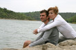 Photo: Couple sat by lake Couple sat by lake