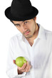 Photo: Man wearing hat and holding apple Man wearing hat and holding apple