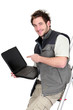 Tiler with a laptop showing a blank screen