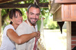 Photo: Friendly couple standing by the barbecue Friendly couple standing by the barbecue