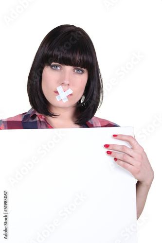 Photo: Talkative woman with her mouth sealed off Talkative woman with her mouth sealed off