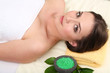 Beautiful young woman lying in spa salon close up