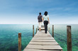 Couple walking on deck at paradise island