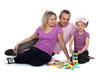 Parents watching their daughter play with blocks