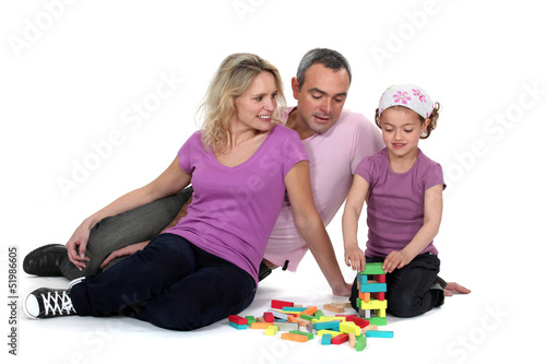 Photo: Parents watching their daughter play with blocks Parents watching their daughter play with blocks