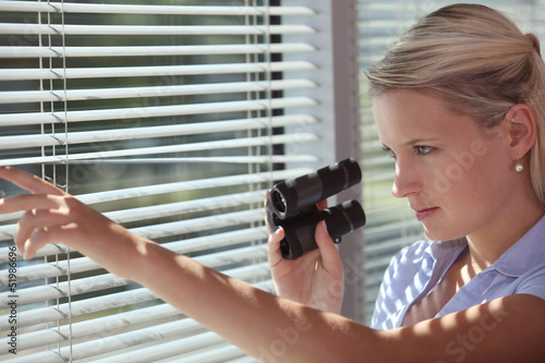 Photo: A spy peering through some blinds A spy peering through some blinds