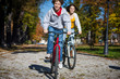 Urban biking - teens riding bikes in city park