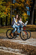 Urban biking - teens riding bikes in city park