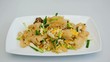 A person is eating fried fish maw. It is a Thai cuisine.