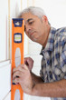 Handyman using spirit level