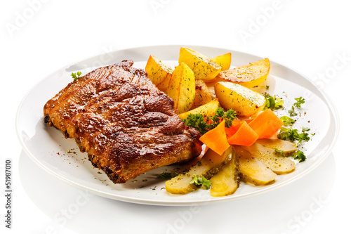 Photo: Tasty grilled ribs with vegetables Tasty grilled ribs with vegetables