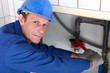 Photo: Plumber using a wrench on a water pipe Plumber using a wrench on a water pipe